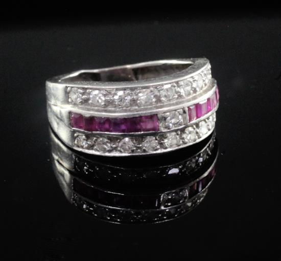 A 1940s white gold, diamond and channel set ruby triple band ring, size approx. K.